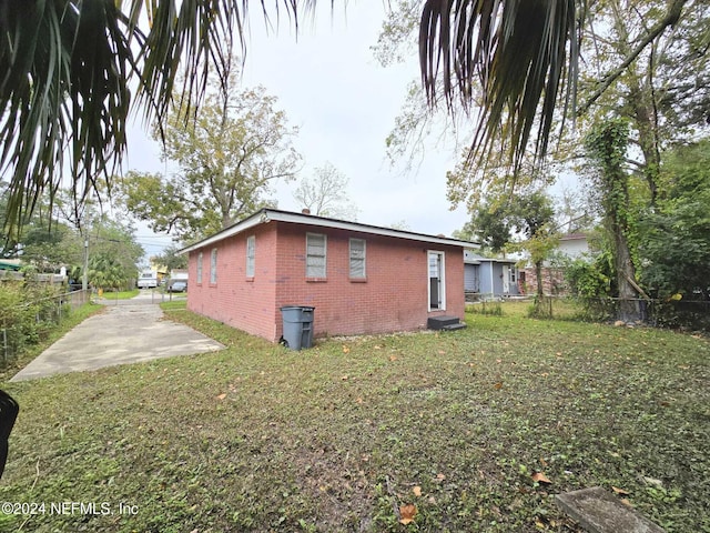 view of home's exterior featuring a yard and a patio area