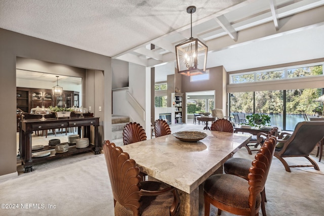 carpeted dining space with beamed ceiling and a textured ceiling