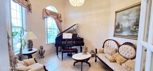 sitting room with light tile patterned floors and a notable chandelier