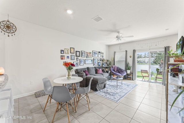 living room with ceiling fan and light tile patterned floors