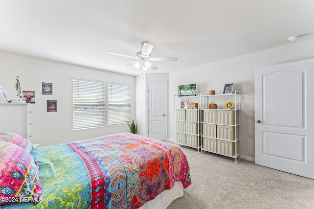 bedroom featuring ceiling fan, light colored carpet, and a closet