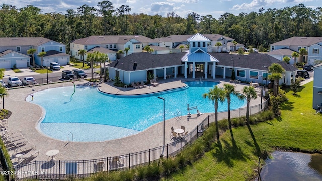 view of swimming pool featuring a lawn and a patio