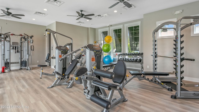 workout area featuring ceiling fan and light hardwood / wood-style floors