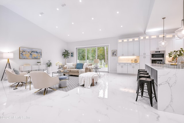 living room featuring high vaulted ceiling