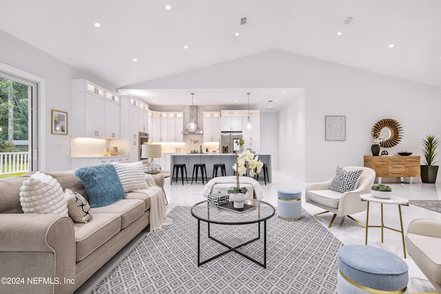 living room featuring vaulted ceiling and light tile patterned floors