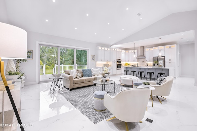 living room featuring sink and vaulted ceiling