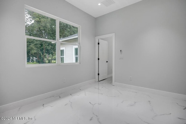 unfurnished room featuring plenty of natural light