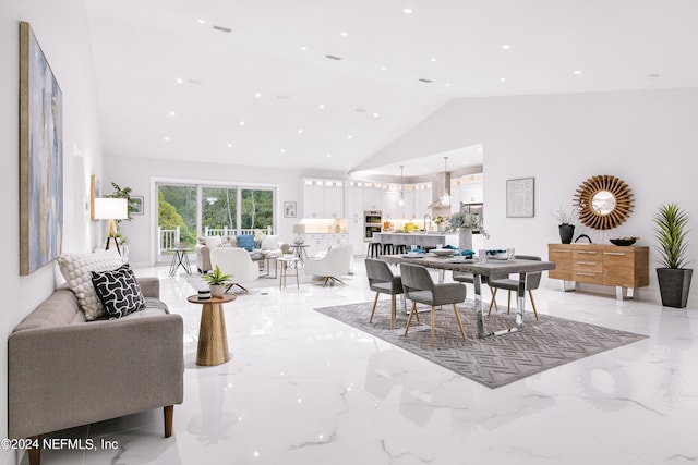 dining area with high vaulted ceiling