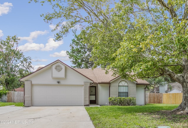 single story home featuring a garage and a front yard