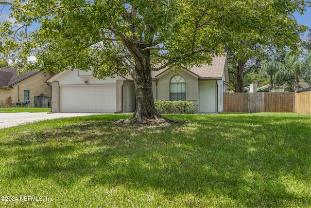 view of front facade featuring a garage and a front lawn