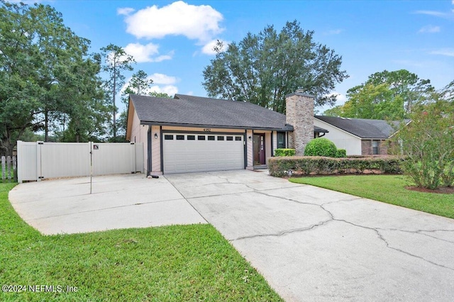 view of front of house with a garage and a front lawn