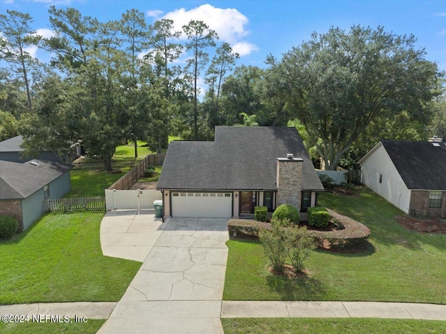 view of front of house with a front lawn and a garage