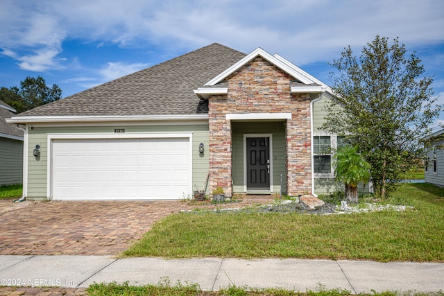 view of front facade with a front yard and a garage