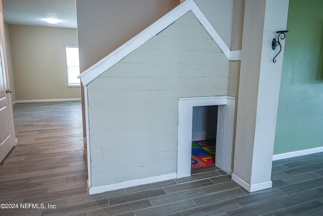 interior space with a textured ceiling and hardwood / wood-style flooring