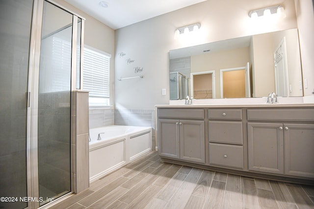 bathroom featuring vanity and separate shower and tub