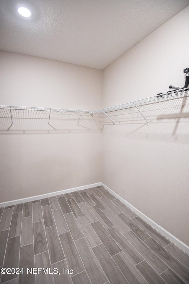 spacious closet featuring hardwood / wood-style floors