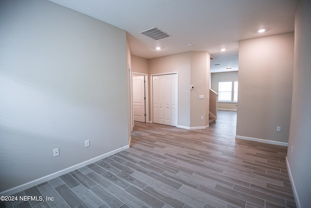 unfurnished room with hardwood / wood-style flooring