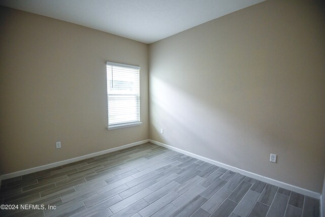 empty room featuring dark wood-type flooring