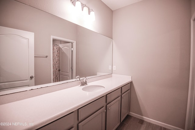 bathroom with vanity and hardwood / wood-style flooring