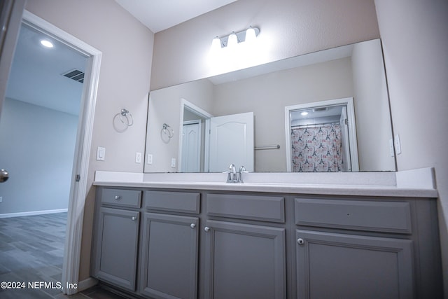 bathroom featuring vanity and hardwood / wood-style floors