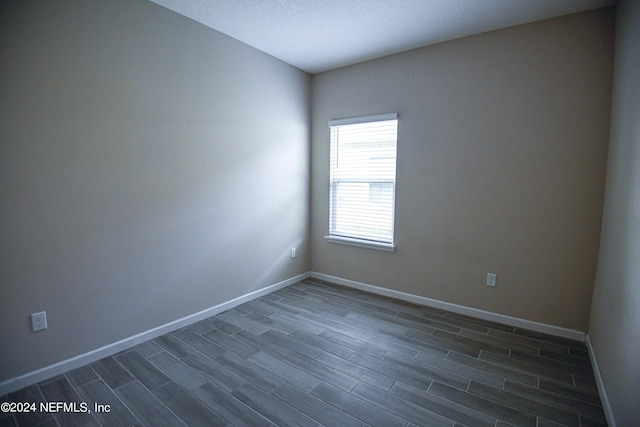 spare room featuring dark hardwood / wood-style floors