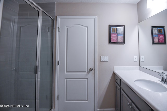 bathroom featuring vanity and an enclosed shower