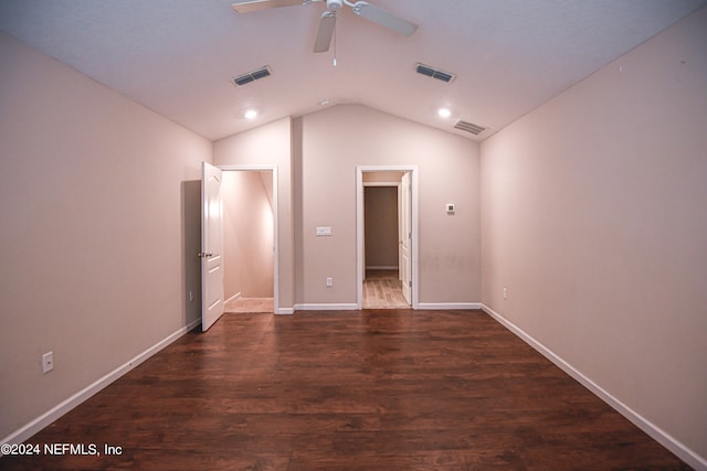 spare room featuring vaulted ceiling, ceiling fan, and dark wood-type flooring