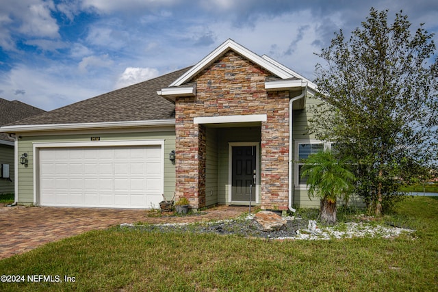 front facade featuring a garage and a front lawn