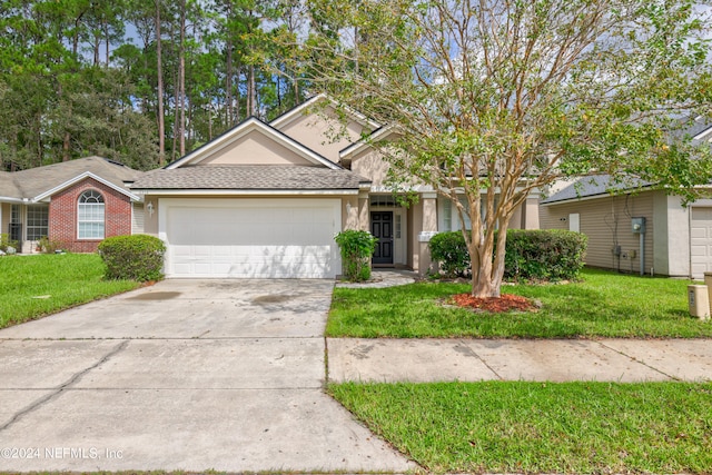 view of front of home featuring a front yard and a garage