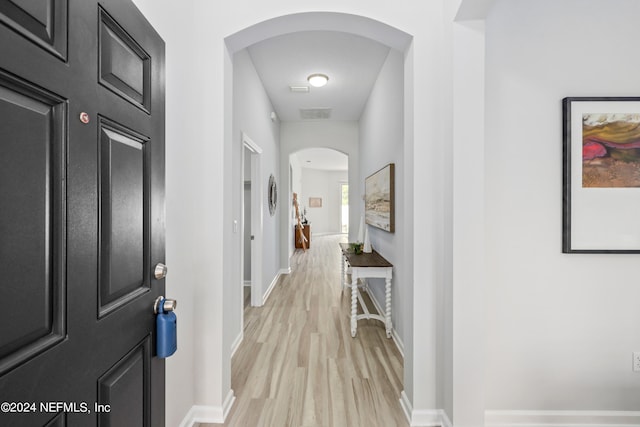 corridor with light hardwood / wood-style flooring