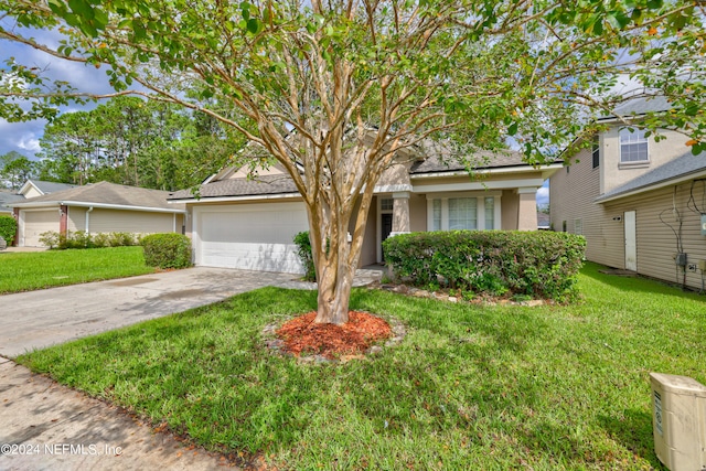 view of front of property with a garage and a front lawn