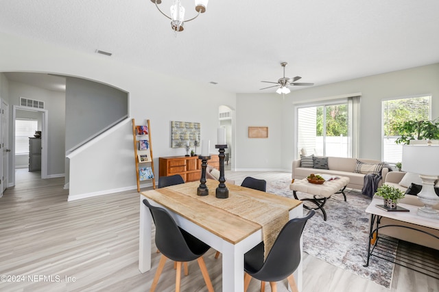 dining space featuring ceiling fan, a textured ceiling, and light hardwood / wood-style flooring