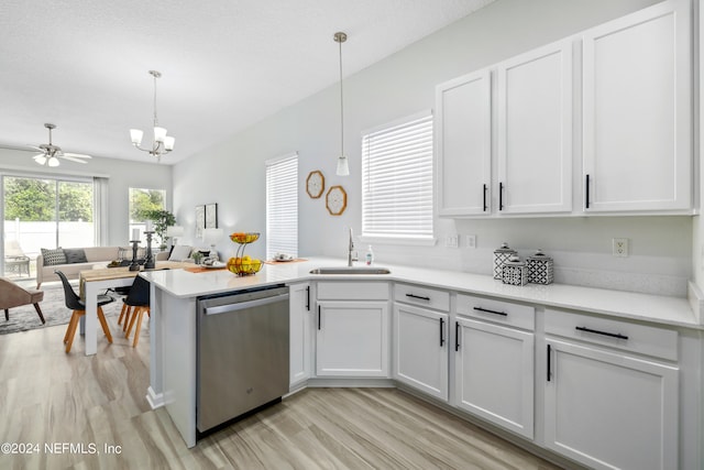 kitchen featuring light wood-type flooring, sink, white cabinetry, hanging light fixtures, and stainless steel dishwasher