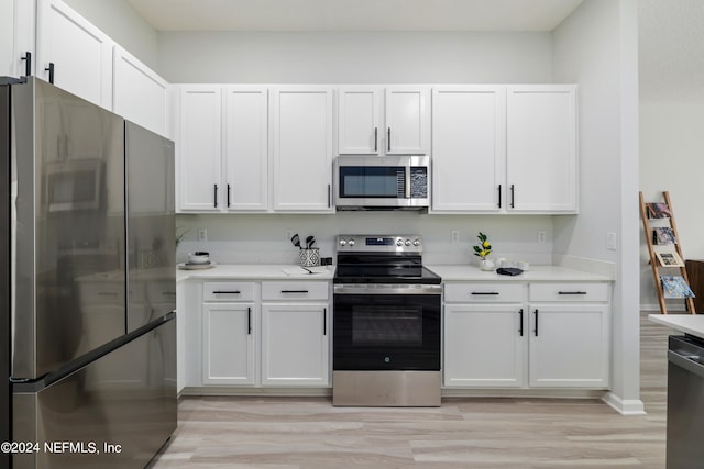 kitchen featuring stainless steel appliances, white cabinets, and light hardwood / wood-style floors