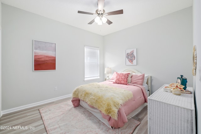 bedroom with light hardwood / wood-style floors and ceiling fan