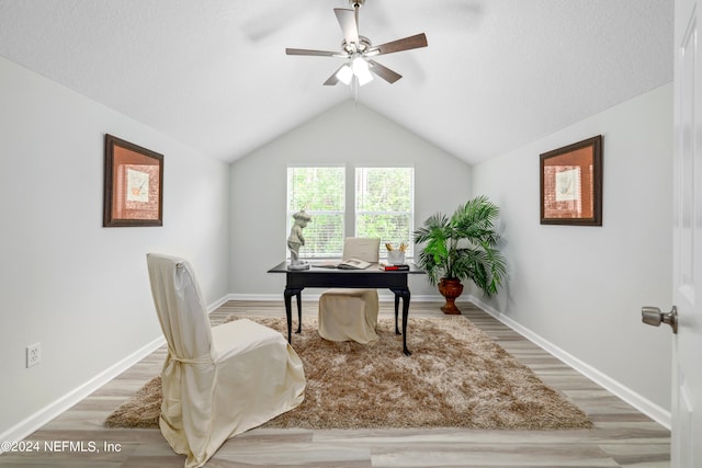 home office featuring ceiling fan, lofted ceiling, and hardwood / wood-style floors