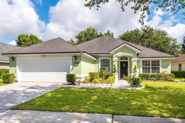 single story home with a garage and a front yard