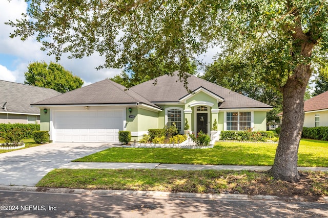 ranch-style house with a garage and a front lawn