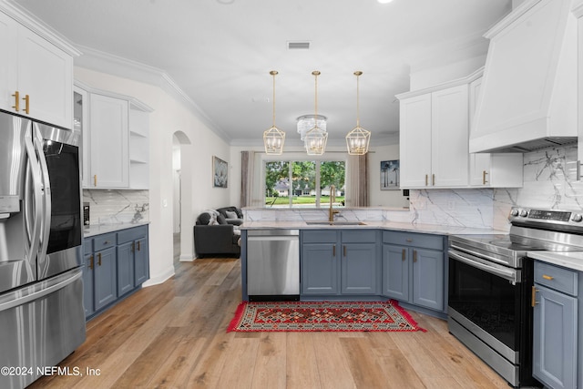 kitchen featuring stainless steel appliances, white cabinets, and light hardwood / wood-style floors