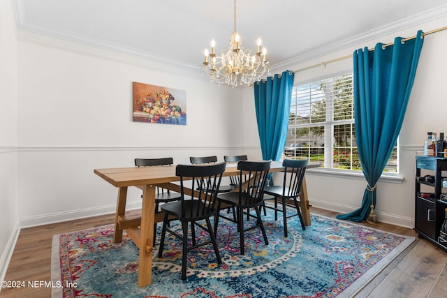 dining room featuring a chandelier, hardwood / wood-style floors, and crown molding