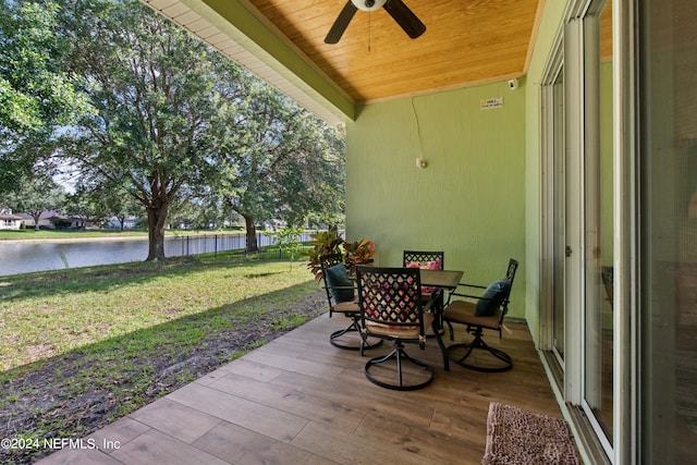 view of patio featuring a water view and ceiling fan