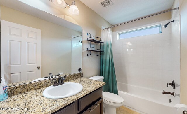 full bathroom featuring shower / bathtub combination with curtain, toilet, vanity, and tile patterned floors