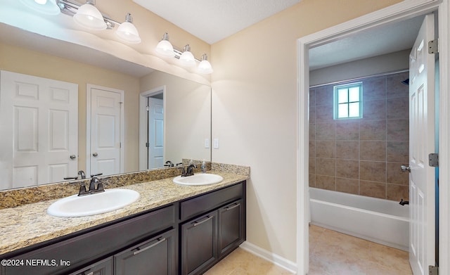 bathroom with vanity, tile patterned floors, and tiled shower / bath