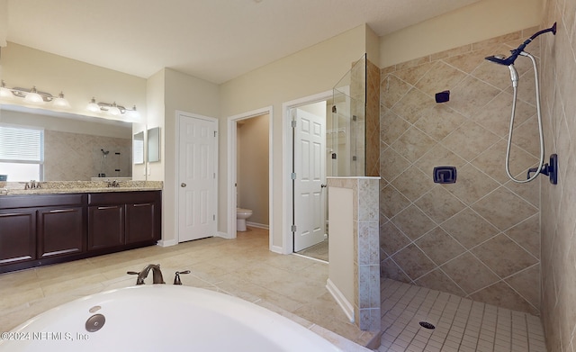 full bathroom with vanity, shower with separate bathtub, toilet, and tile patterned floors