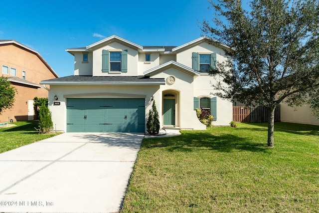 view of front of house with a front yard and a garage