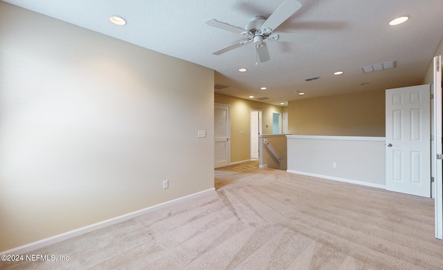 carpeted empty room featuring ceiling fan