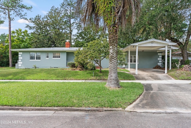 ranch-style home featuring a carport and a front yard