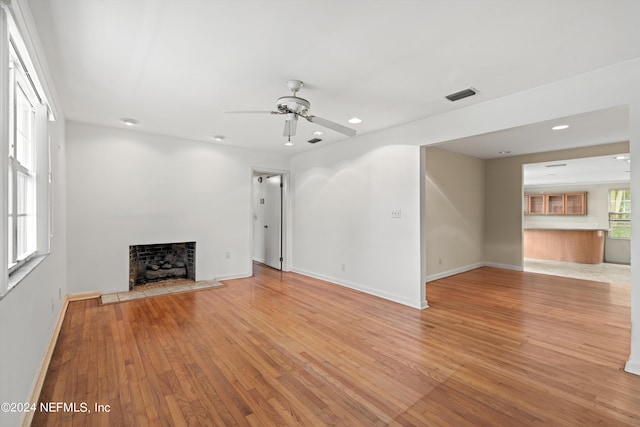 unfurnished living room featuring light hardwood / wood-style floors and ceiling fan