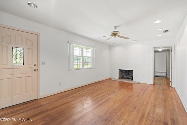 unfurnished living room with ceiling fan and light wood-type flooring