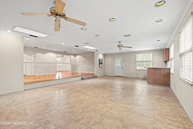 spare room with crown molding and ceiling fan